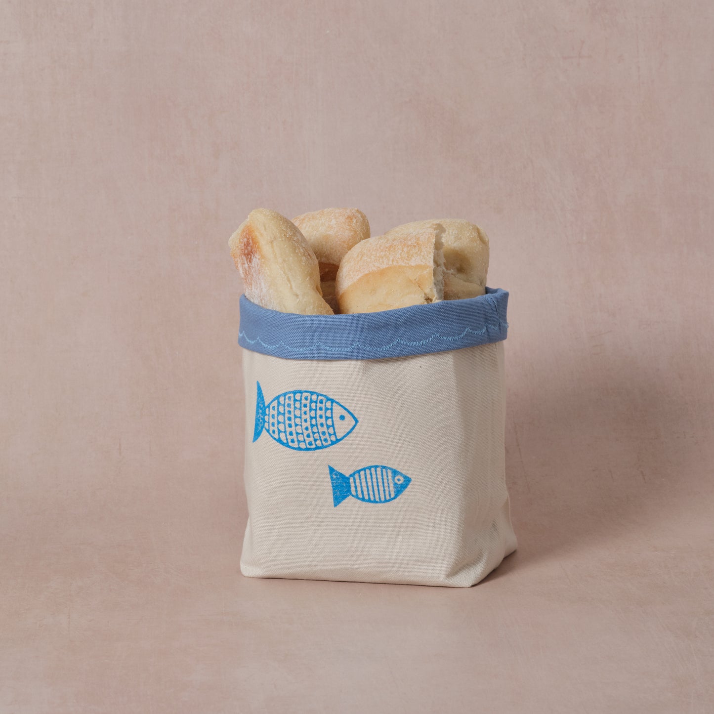 Reversible block-printed fabric storage basket in fish print, handmade cotton basket by Emena Home UK